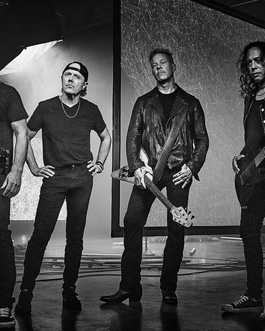 Metallica in a black-and-white promotional portrait, Lars Ulrich and James Hetfield centre-frame with guitars - the official tour image